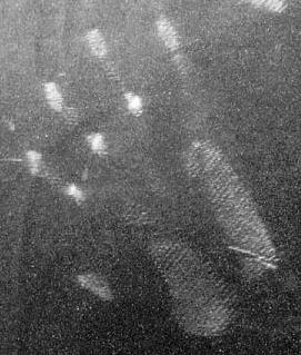 Photo: a white handprint with fine square hatching pattern